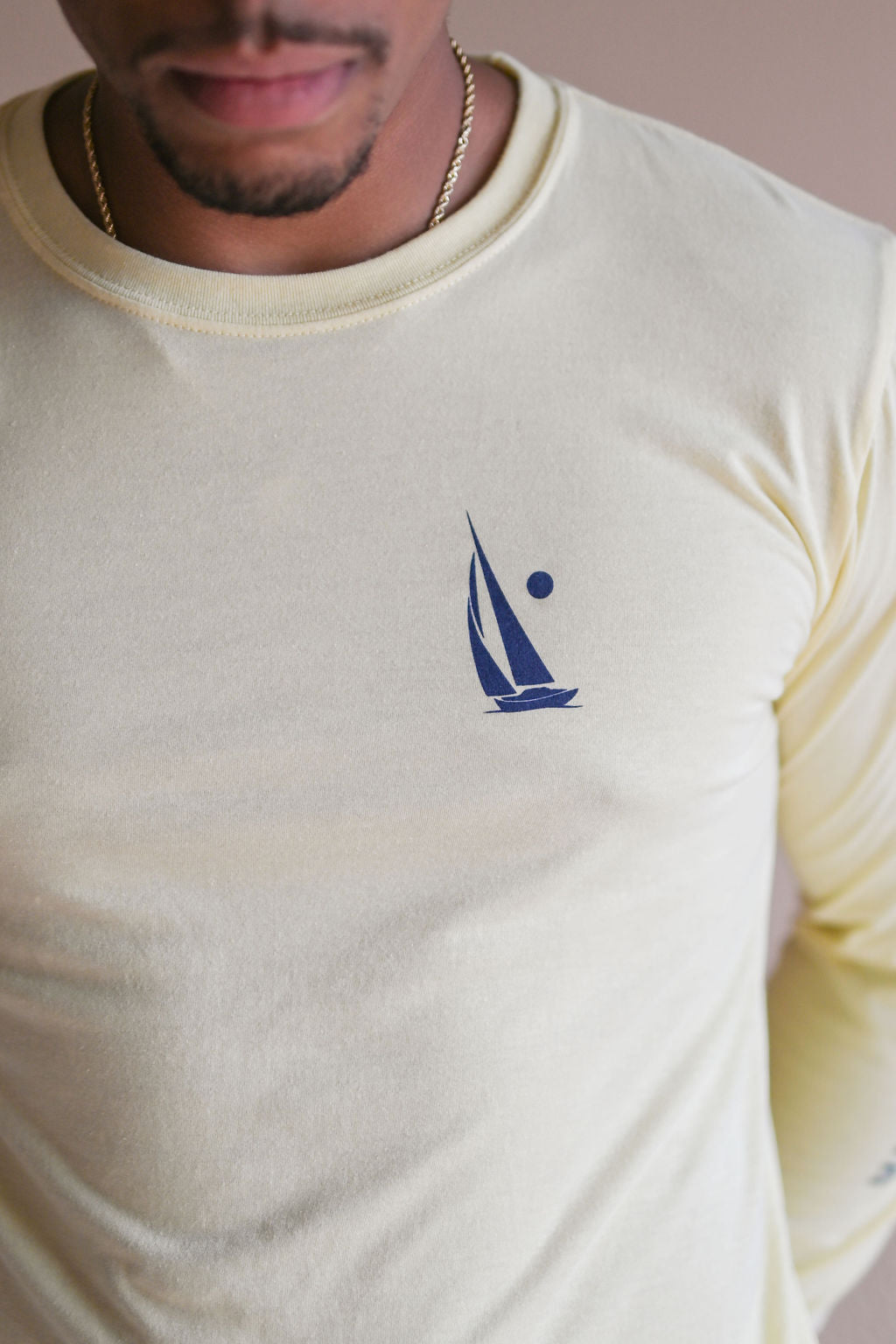 Unisex long sleeve organic shirt with blue sail boat logo and text