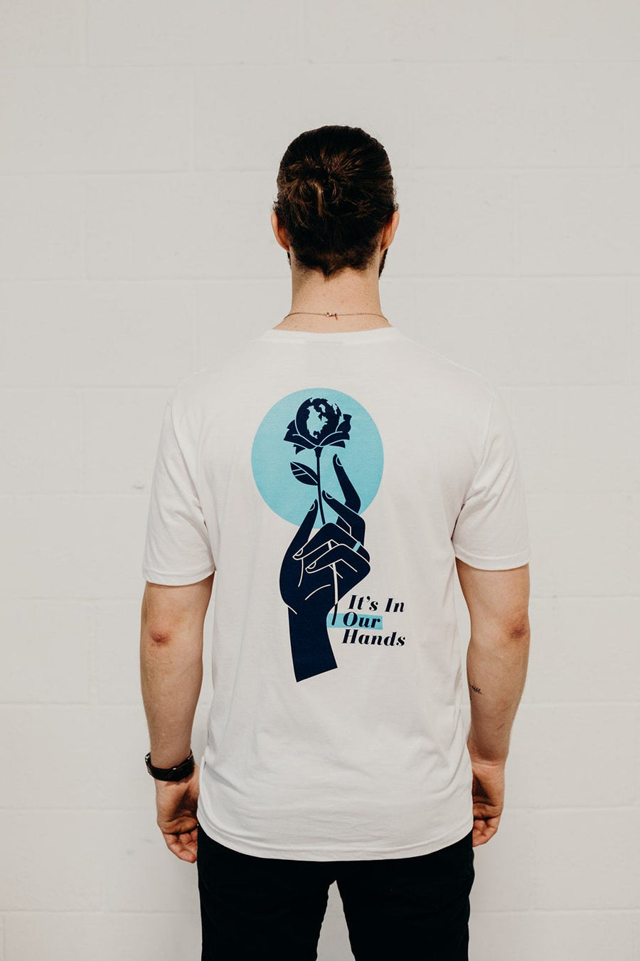 White organic short sleeve unisex t-shirt with blue "it's in our hands" Ungalli logo on front and across back