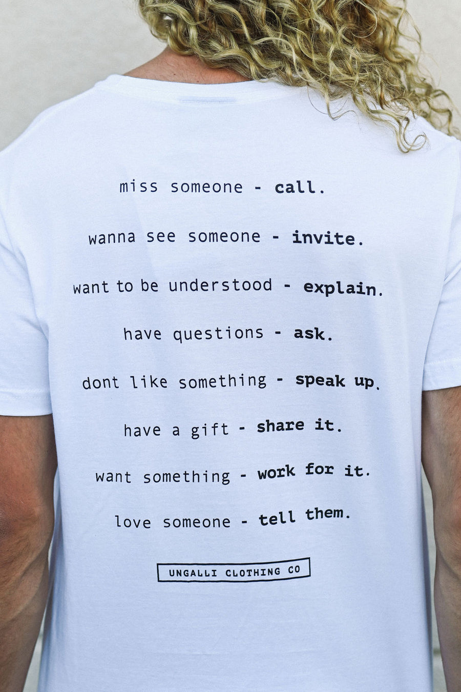 White unisex organically made t-shirt with black text on back