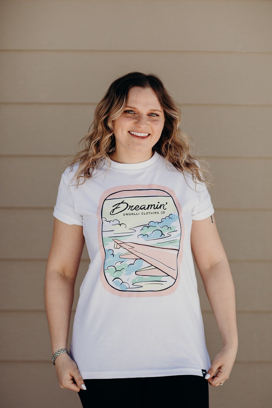 Organic white unisex t-shirt with multi-coloured dreamin' plane logo on front