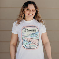 Organic white unisex t-shirt with multi-coloured dreamin' plane logo on front