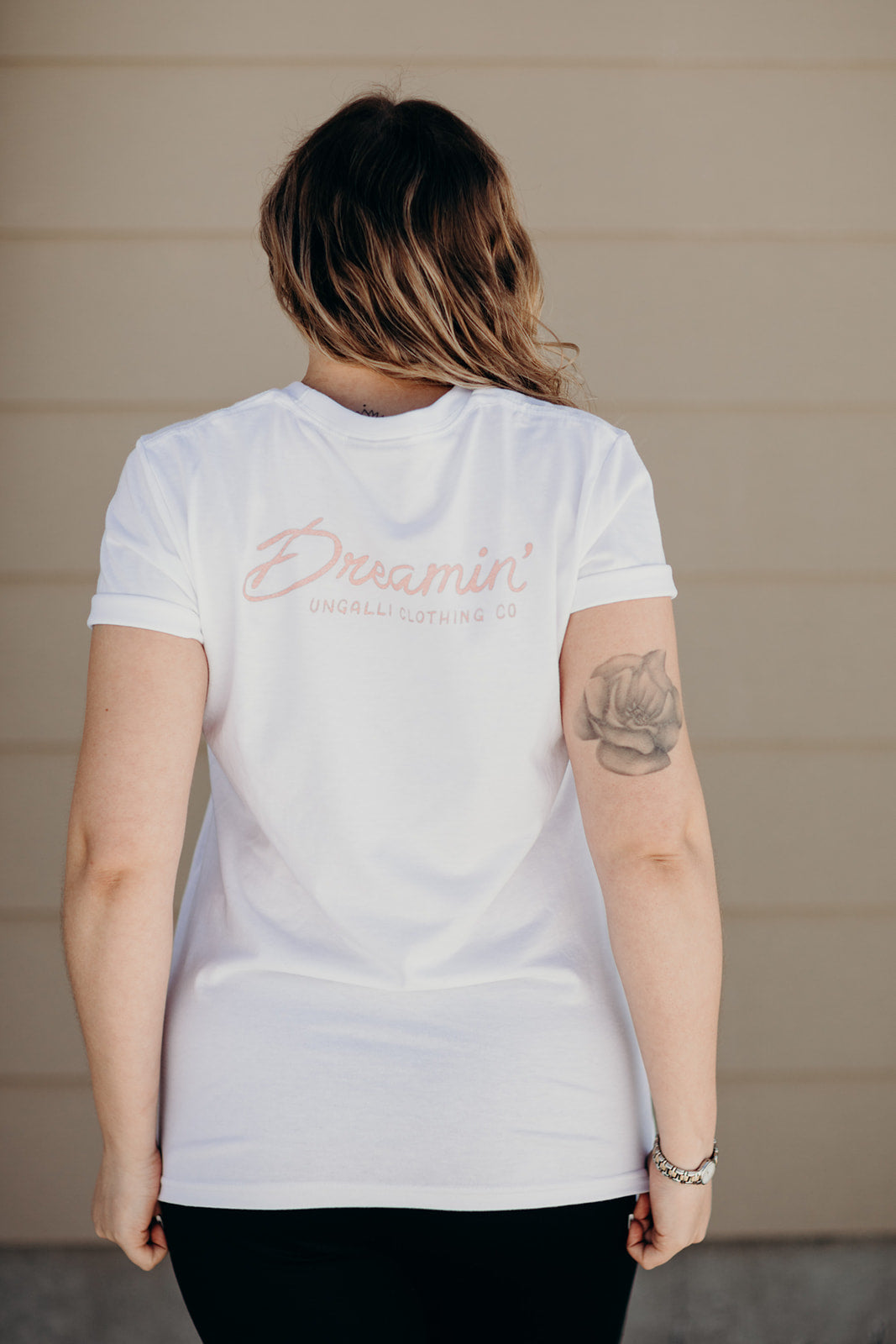 Organic white unisex t-shirt with multi-coloured dreamin' plane logo on front