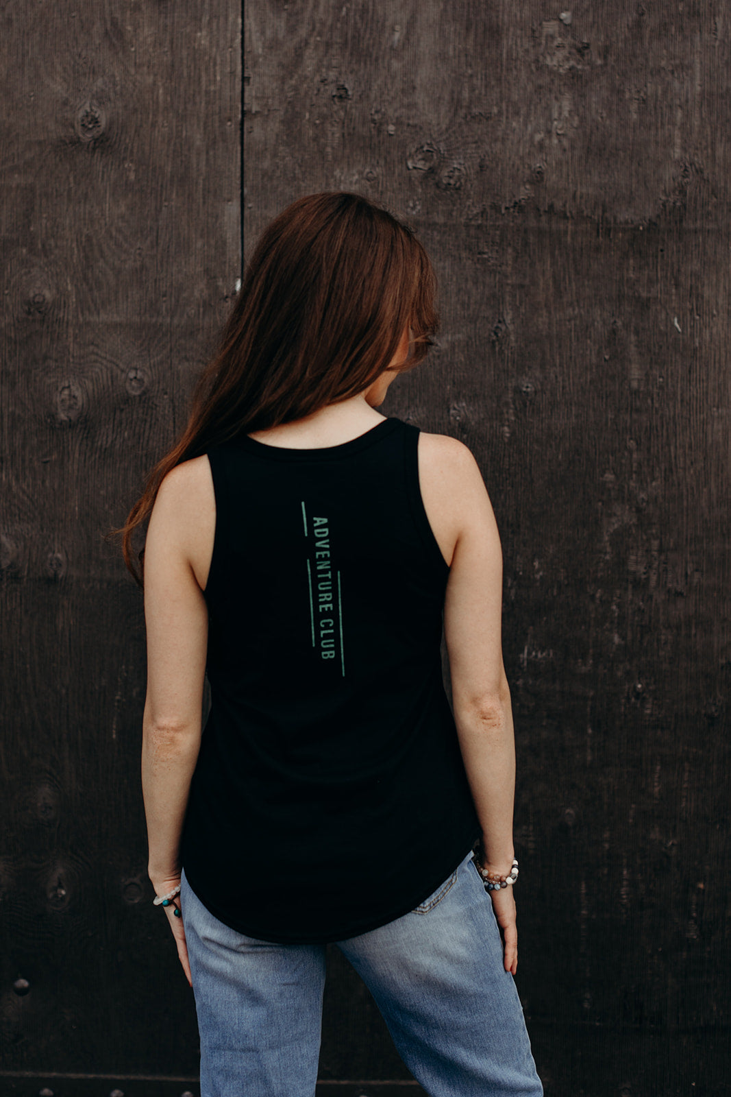 women's black recycled tank top with multi coloured 'adventure club' logo