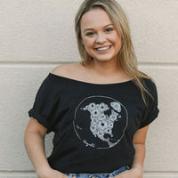 Women's black ethically sourced off the shoulder t-shirt with floral map design on front