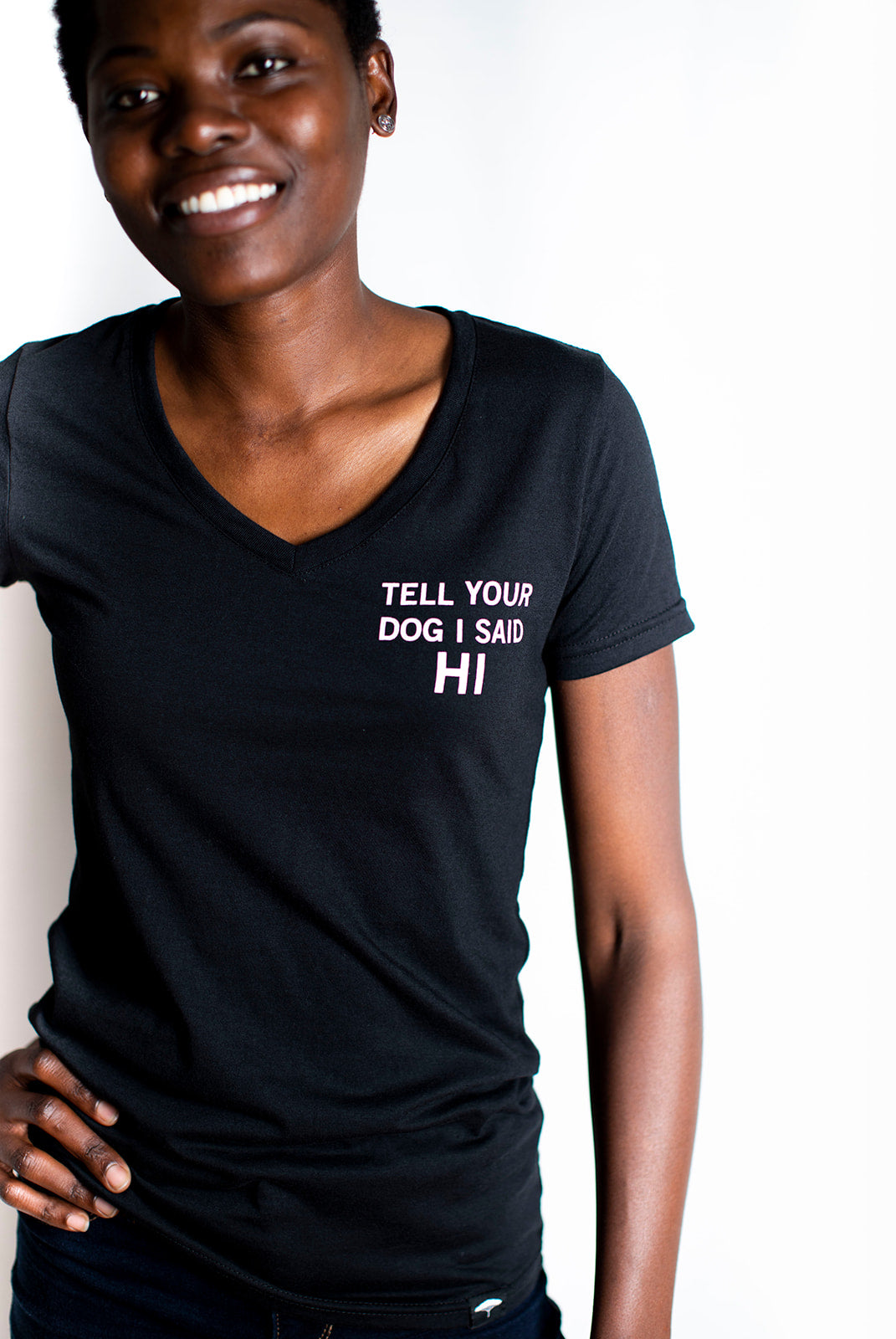 Women's organic short sleeve black t-shirt with text that reads 'Tell your dog I said HI' on front