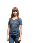 Women's short sleeve organic blue t-shirt with text reading: "Never forget where your voyage starts"