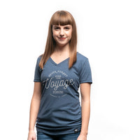 Women's short sleeve organic blue t-shirt with text reading: "Never forget where your voyage starts"