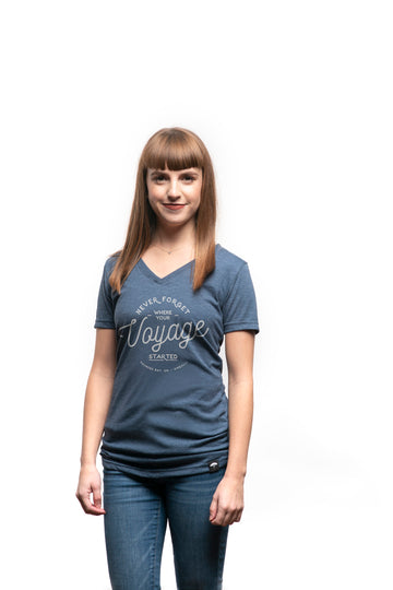 Women's short sleeve organic blue t-shirt with text reading: "Never forget where your voyage starts"