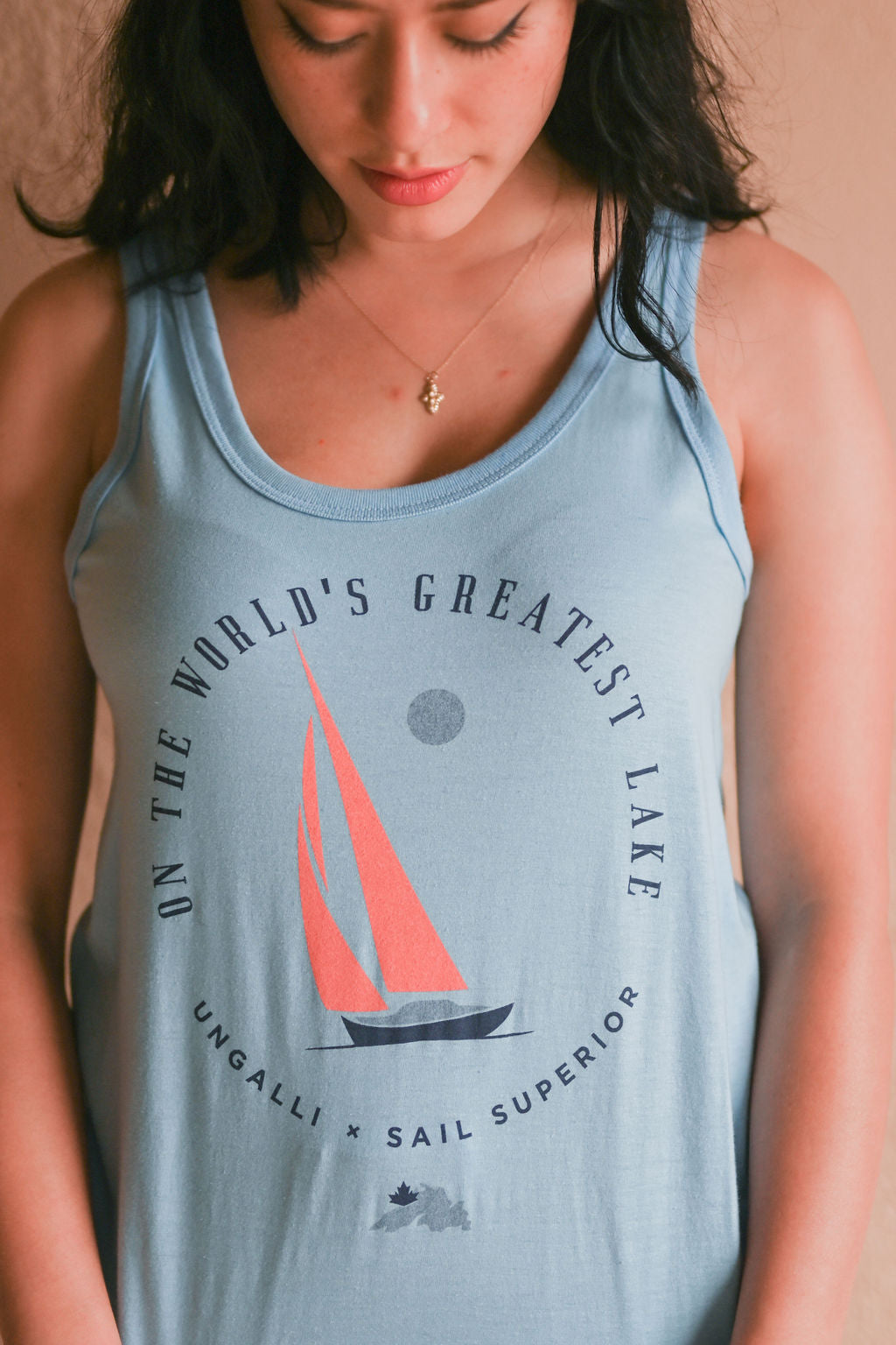 Women's sustainable blue tank top with Sail Superior logo on front