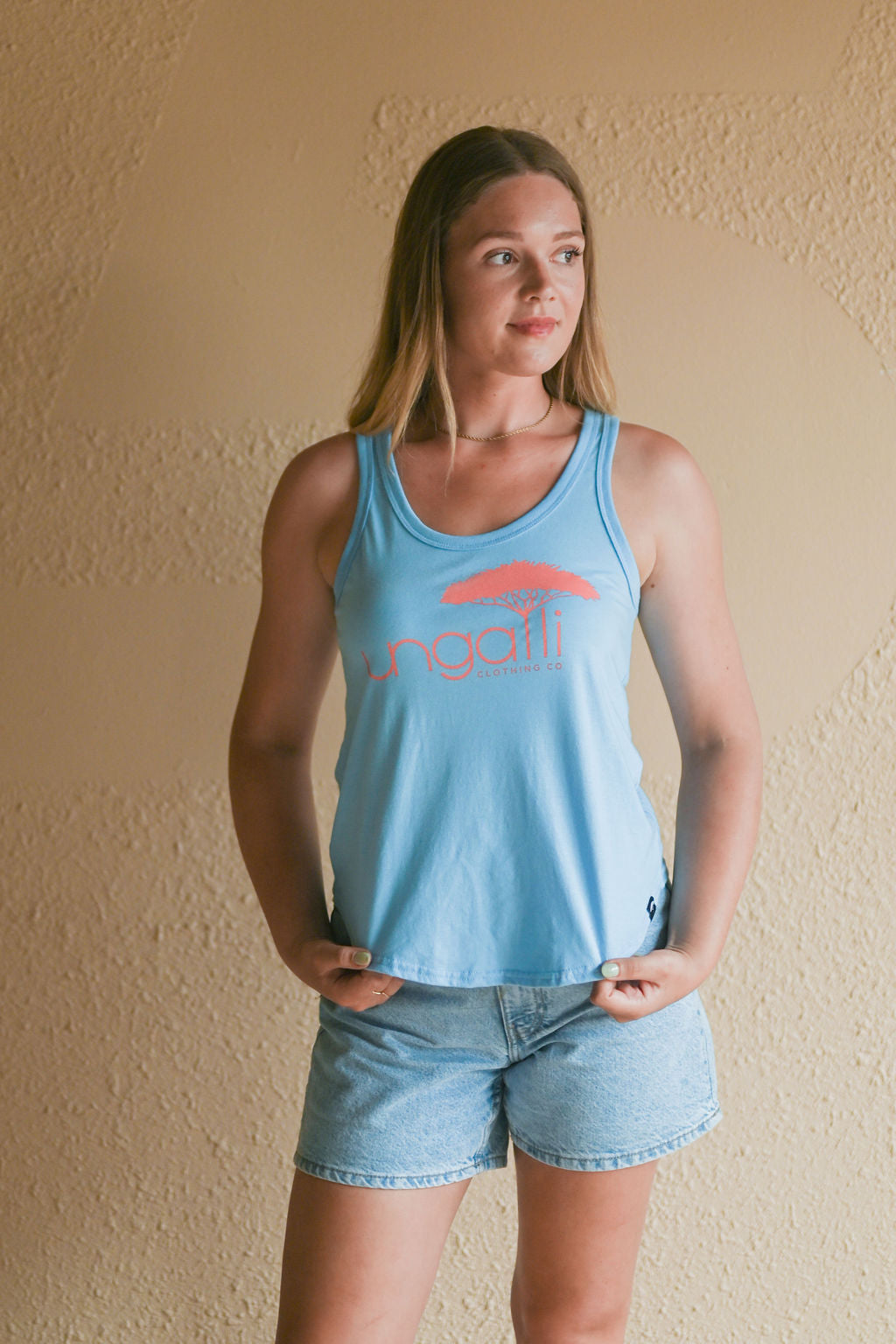 Women's organic blue tank top with pink Ungalli logo on front
