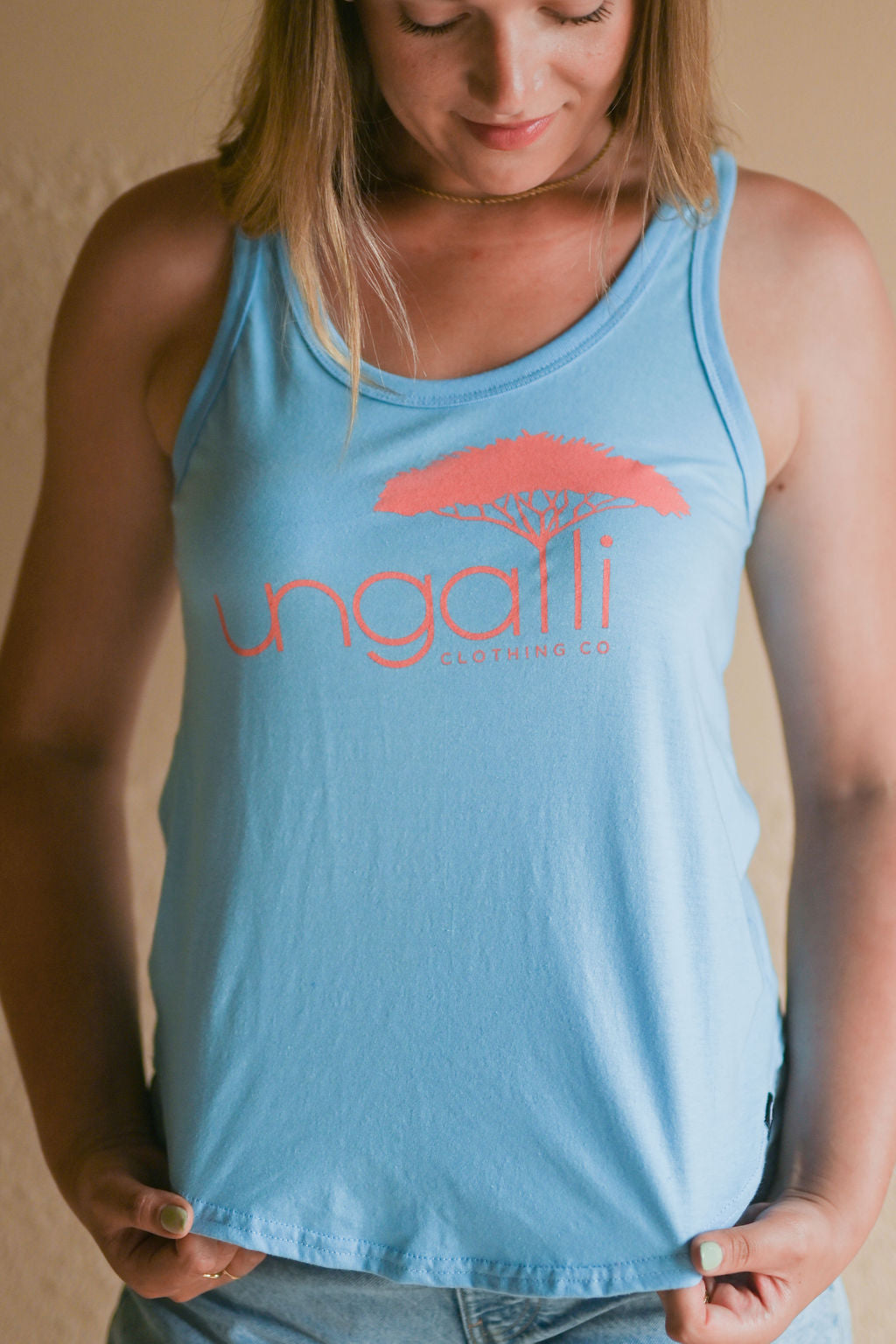 Women's organic blue tank top with pink Ungalli logo on front