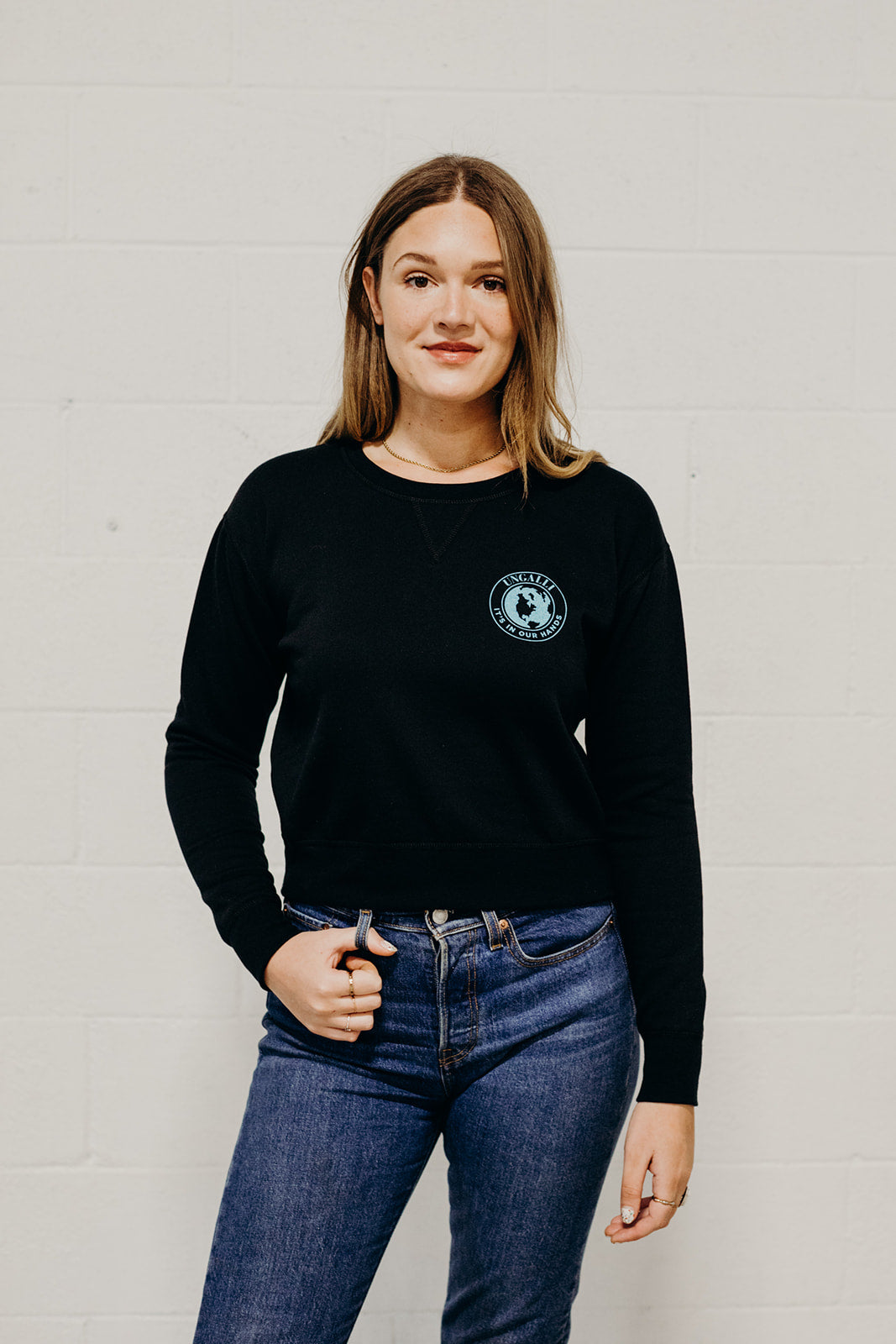 Women's sustainably made black cropped hoodie with brand logo