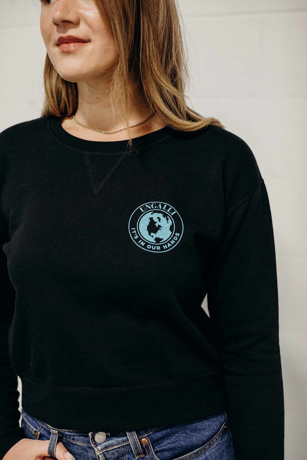 Women's sustainably made black cropped hoodie with brand logo