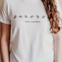 Women's white organically made t-shirt with bee design on front