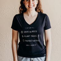 Women's short sleeve black ethically made t-shirt with text that reads: "I just want to.. save the bees, plant trees & protect our seas"