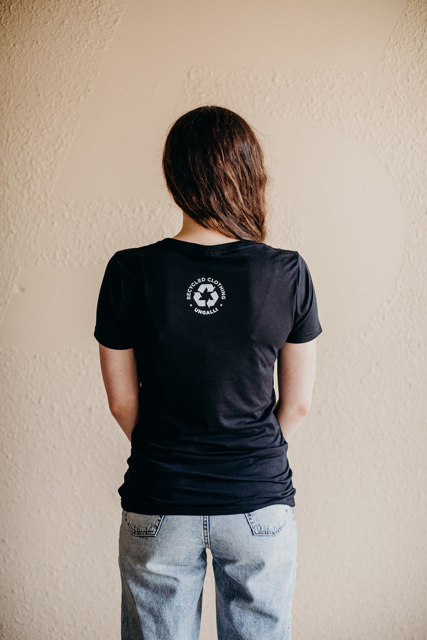 Women's short sleeve black ethically made t-shirt with text that reads: "I just want to.. save the bees, plant trees & protect our seas"