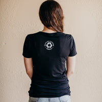 Women's short sleeve black ethically made t-shirt with text that reads: "I just want to.. save the bees, plant trees & protect our seas"