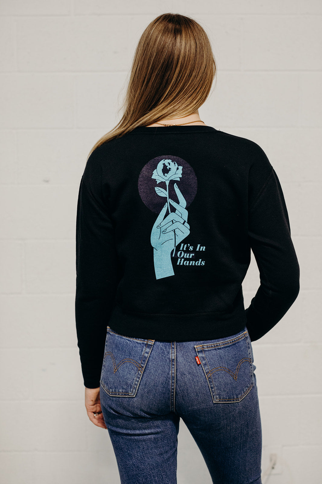 Women's sustainably made black cropped hoodie with brand logo