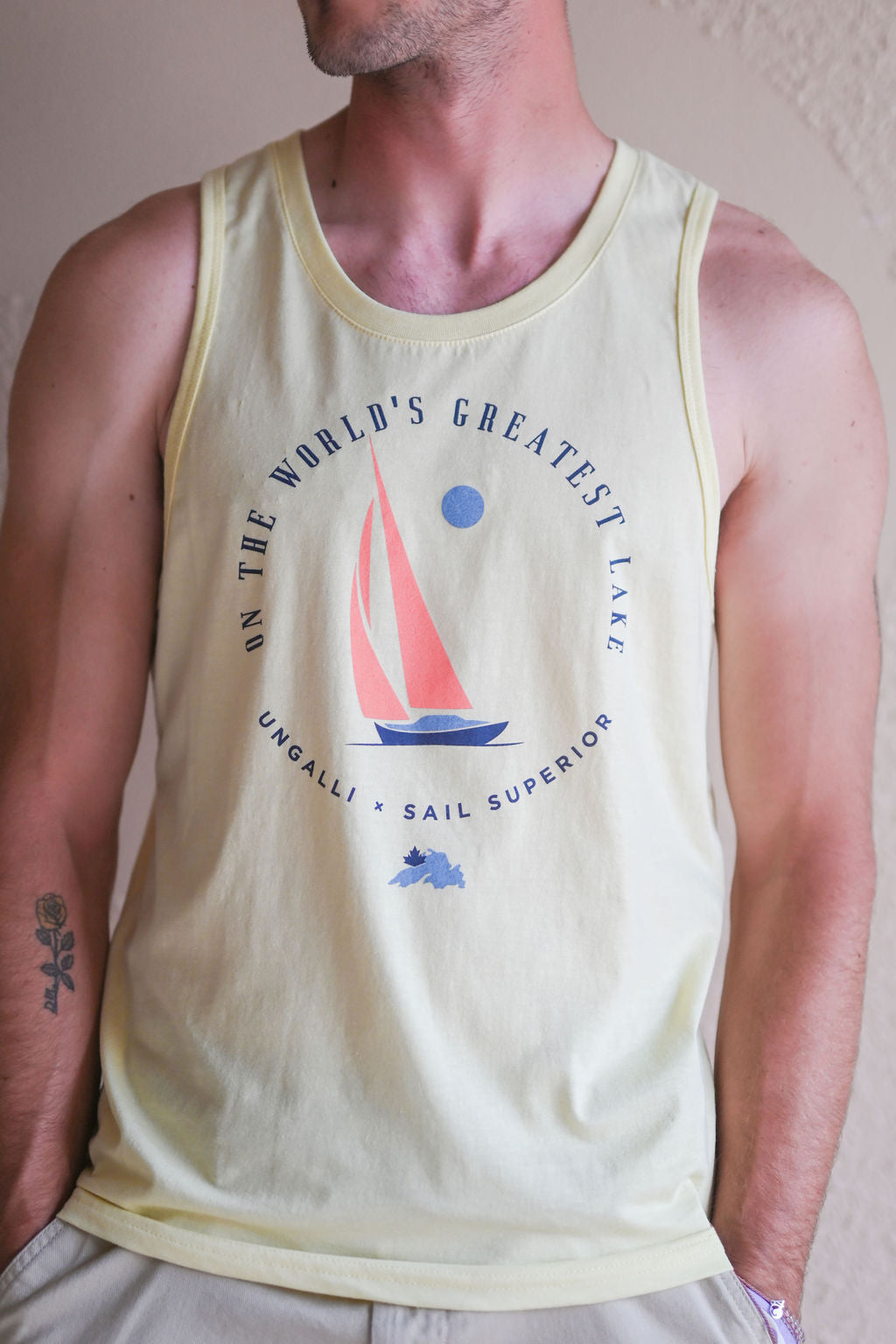 Men's yellow ethically made tank top with sail boat 'greatest lake' design on front