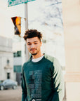 Organically made green unisex  crew neck pull over sweater with white text